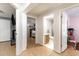 A hallway with hardwood floors leads to the bathroom and bedrooms at 5141 Nc-39 N Hwy, Henderson, NC 27537