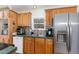 Kitchen featuring wooden cabinets, stainless steel appliances, and a window above the sink at 5141 Nc-39 N Hwy, Henderson, NC 27537