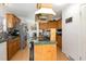 A bright kitchen with wood cabinets, updated stainless steel appliances, and view to the dining area at 5141 Nc-39 N Hwy, Henderson, NC 27537