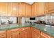 The wood cabinetry and solid surface counter in this kitchen creates a stylish and functional workspace at 5141 Nc-39 N Hwy, Henderson, NC 27537