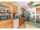 A kitchen with a microwave in an open wood cabinet, stainless appliances, and tile backsplash at 5141 Nc-39 N Hwy, Henderson, NC 27537