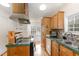 A cozy kitchen featuring wood cabinetry and a window allowing natural light to brighten the space at 5141 Nc-39 N Hwy, Henderson, NC 27537