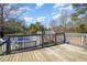 View of a pool with a wooden deck and surrounding trees at 5141 Nc-39 N Hwy, Henderson, NC 27537