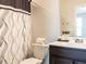 Bathroom with decorative shower curtain and a dark wood vanity offers a modern touch at 5238 Beardall St, Raleigh, NC 27616
