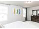 Bright bedroom with natural light, white walls, and feather artwork adds a modern touch at 5238 Beardall St, Raleigh, NC 27616
