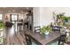 Open-concept dining area with dark wood table, leads to the kitchen with stainless steel appliances at 5238 Beardall St, Raleigh, NC 27616
