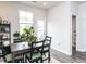 Cozy dining area with a dark wood table, green cushioned chairs, and a window view at 5238 Beardall St, Raleigh, NC 27616