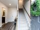 Welcoming entryway with hardwood floors, staircase, and a view into the downstairs bathroom at 5238 Beardall St, Raleigh, NC 27616