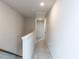 Upstairs hallway with neutral carpet, white walls, and access to multiple rooms at 5238 Beardall St, Raleigh, NC 27616
