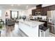 Stylish kitchen with stainless steel appliances, a kitchen island, and a view of the living area at 5238 Beardall St, Raleigh, NC 27616