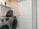 Laundry room area with modern appliances and storage shelving at 5238 Beardall St, Raleigh, NC 27616
