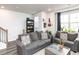 Inviting living room with a couch, loveseat, and built-in bookshelves with a window at 5238 Beardall St, Raleigh, NC 27616