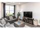 Comfortable living room featuring large windows, cozy seating, and stylish decor at 5238 Beardall St, Raleigh, NC 27616