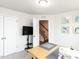 Well lit crafting room with large table, a sewing machine, and art on the walls at 5238 Beardall St, Raleigh, NC 27616