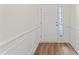 Clean and bright entryway with white wainscoting and wood floors at 525 Whitworth Ln, Morrisville, NC 27560