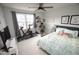 Cozy bedroom with large window, ceiling fan, and a comfortable bed at 5806 Empathy Ln, Raleigh, NC 27616