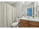 Clean bathroom with wood vanity, white sink, and neutral decor at 5809 Neuse Wood Dr, Raleigh, NC 27616