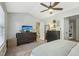 Spacious bedroom with large windows, ceiling fan and en-suite bathroom access at 5809 Neuse Wood Dr, Raleigh, NC 27616