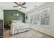 Bright bedroom with green accent wall, ceiling fan, and ample natural light at 5809 Neuse Wood Dr, Raleigh, NC 27616