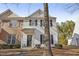 Two-story home with brick and vinyl siding, showcasing its inviting curb appeal at 5809 Neuse Wood Dr, Raleigh, NC 27616