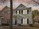 Two-story townhome with light-colored siding, dark trim, and a charming front porch at 5809 Neuse Wood Dr, Raleigh, NC 27616