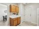 Small kitchen with wood cabinets, white countertops, and access to the garage at 5809 Neuse Wood Dr, Raleigh, NC 27616