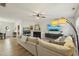 Bright living room with L-shaped sofa, fireplace, and large windows at 5809 Neuse Wood Dr, Raleigh, NC 27616