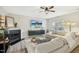 Spacious living room with L-shaped sofa, fireplace, and large TV at 5809 Neuse Wood Dr, Raleigh, NC 27616