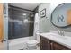 Bathroom with dark-tiled shower and updated vanity at 5920 Orchid Valley Rd, Raleigh, NC 27613