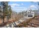 Long driveway leading to a two-story house nestled in a wooded area at 5920 Orchid Valley Rd, Raleigh, NC 27613