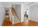 Bright hallway with hardwood floors, staircase, and views of bathroom and bedroom at 5920 Orchid Valley Rd, Raleigh, NC 27613