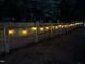 Fenced-in backyard enhanced by ambient string lights, creating an inviting outdoor space at 5920 Whittier Dr, Raleigh, NC 27609