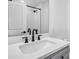 Bright bathroom with updated vanity, marble countertops, and a modern shower with glass door at 5920 Whittier Dr, Raleigh, NC 27609