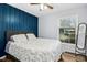 Bedroom with a decorative accent wall and large window providing lots of natural light at 5920 Whittier Dr, Raleigh, NC 27609