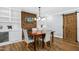 Dining room with fireplace and barn door, featuring built-in shelves and hardwood floors at 5920 Whittier Dr, Raleigh, NC 27609