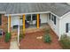 Inviting front porch with yellow columns and comfortable seating, enhancing the home's curb appeal at 5920 Whittier Dr, Raleigh, NC 27609