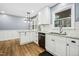Updated kitchen featuring white cabinets, granite countertops, and stainless appliances at 5920 Whittier Dr, Raleigh, NC 27609
