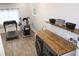 Open laundry room featuring wooden countertops, sink, updated washer and dryer, vinyl floors, and exercise equipment at 5920 Whittier Dr, Raleigh, NC 27609