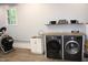 Bright laundry area featuring wood countertops, updated washer and dryer, sink, and exercise equipment at 5920 Whittier Dr, Raleigh, NC 27609