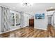 Bright living room boasts wood floors, ample natural light, and modern light fixture at 5920 Whittier Dr, Raleigh, NC 27609