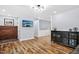 Open living room featuring wood floors, light gray walls, and stylish light fixture at 5920 Whittier Dr, Raleigh, NC 27609