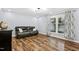 Living room featuring hardwood floors, large window, and leather sofa at 5920 Whittier Dr, Raleigh, NC 27609