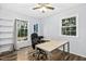 Bright office space featuring hardwood floors, a ceiling fan, desk, and two windows for natural light at 5920 Whittier Dr, Raleigh, NC 27609