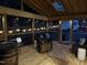 Outdoor screened-in porch with wood flooring, stylish seating, and string lights for evening ambiance at 5920 Whittier Dr, Raleigh, NC 27609