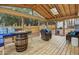 Relaxing screened in porch featuring wood floors and a unique fire pit table, great for entertaining at 5920 Whittier Dr, Raleigh, NC 27609