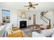 Cozy living room features a fireplace, built-in window seat, and hardwood floors at 6324 Fauvette Ln, Holly Springs, NC 27540