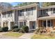 Exterior view of charming townhome with gray siding and landscaping at 69 Forest Oaks Dr, Durham, NC 27705