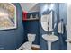 Stylish powder room with a pedestal sink, unique decor, and blue accent wall at 75 Pearsall Farm Ln, Clayton, NC 27527