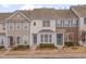 Charming townhome exteriors with landscaped front yards and coordinated color palettes at 7860 Silverthread Ln, Raleigh, NC 27617