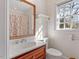 Small bathroom with single sink vanity and window at 806 E Franklin St, Chapel Hill, NC 27514